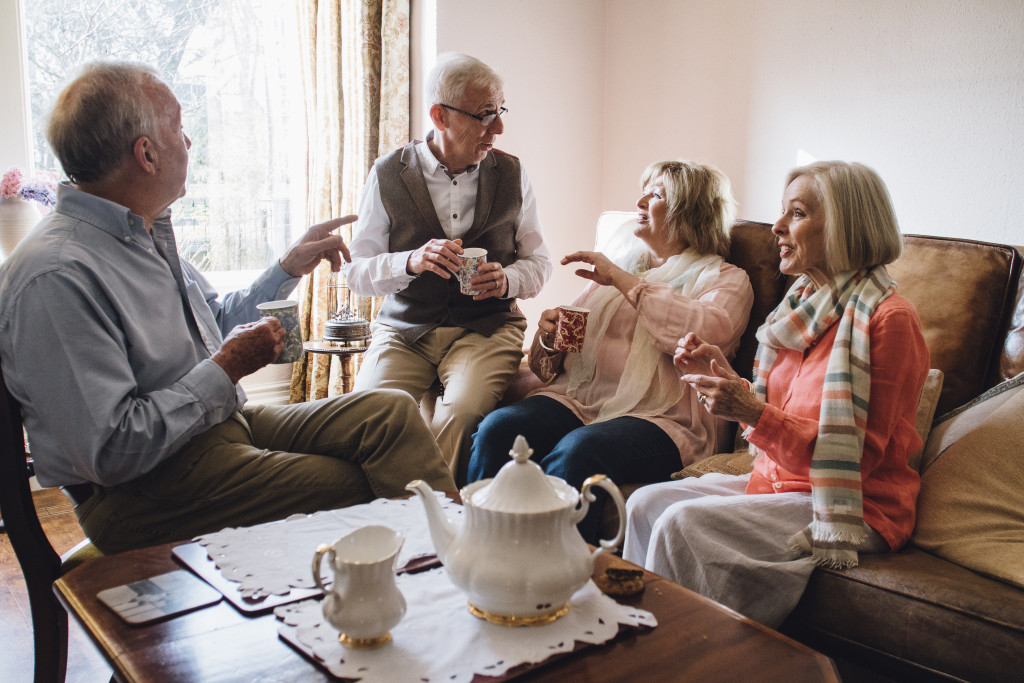 Senior adults talking at the living area of a home.