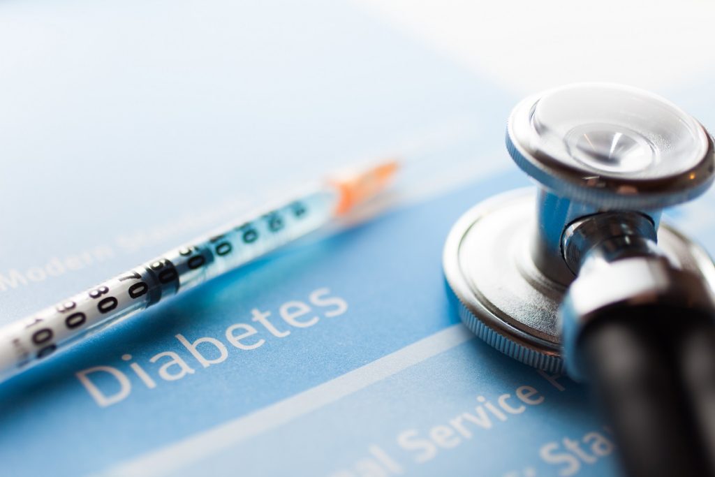 stethoscope and a syringe on diabetes test