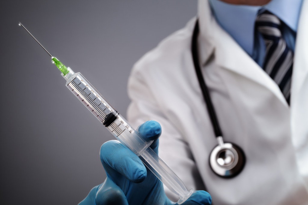 a doctor holding syringe