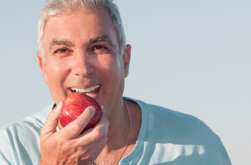 senior man eating apple