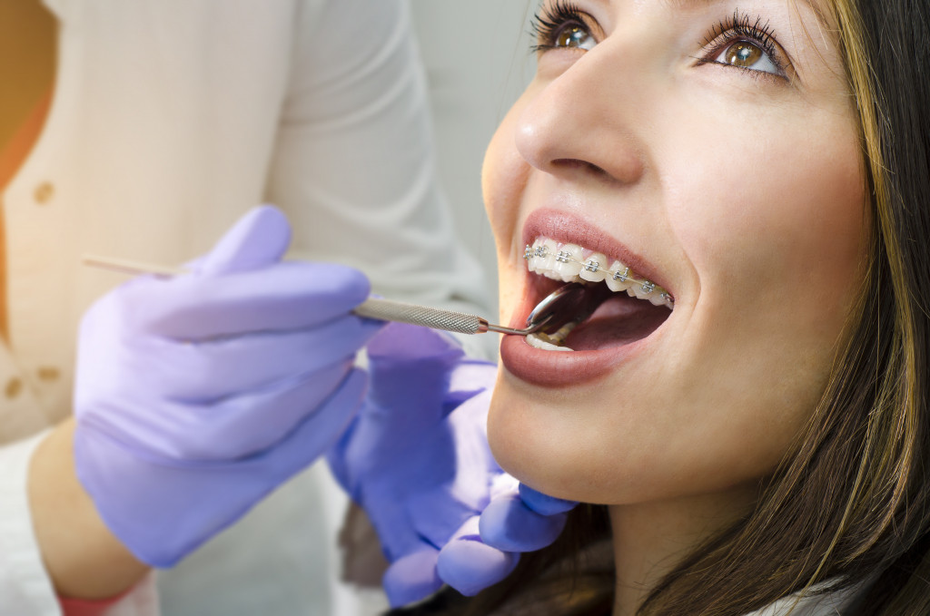 woman wearing braces in dentist